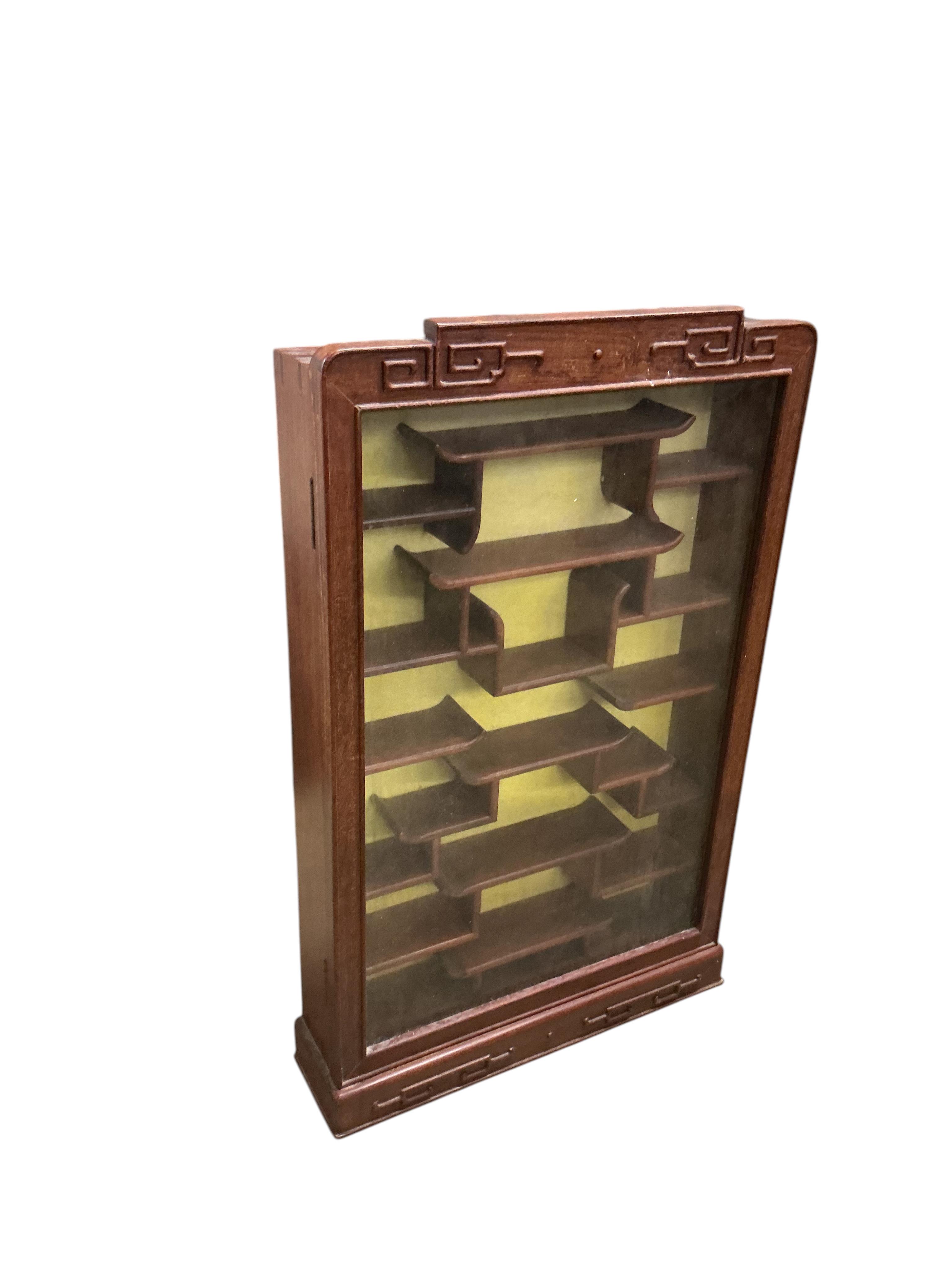 A pair of Chinese carved hardwood wall display cabinets, width 43cm, depth 10cm, height 71cm